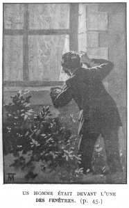 A man was crouching before one of the windows of the house.