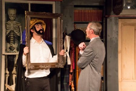 Sherlock Holmes (Brad Loffswold) ponders a painting at Baskerville Hall (Jake Guidi)