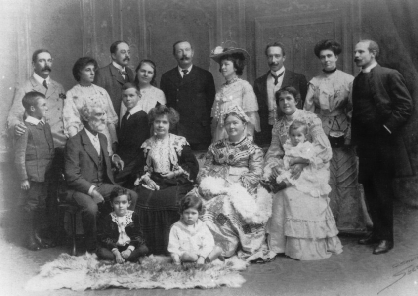 1904: Standing from left to right: Innes Doyle with young Arthur Oscar Hornung, Constance Doyle (Connie), Ernest W. Hornung, Mary and Kingsley, Arthur Conan Doyle, Caroline Doyle (Lottie) and Leslie Oldham, Bryan Mary Doyle (Dodo) and Cyril Angell. Seated from left to right: Nelson Foley, Louisa Conan Doyle, Mary Doyle (The Ma'am), Ida Foley with Innes Foley. Seated on floor: Percy Foley and Branford Angell.