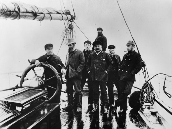 Arthur Conan Doyle on the deck of the Eira (12 july 1880). From left to right: David Gray at the helm (Capt. Eclipse), Benjamin Leigh-Smith (Capt./owner Eira), Arthur Conan Doyle (Surgeon Hope), John Gray (Capt. Hope), Dr. Walker, Dr. Neale, and William Lofley (ice master Eira) right at the stern.
