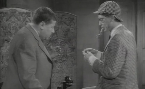 Francis Blanche as Édouard / Dr. Watson with Darry Cowl as Félix / Sherlock Holmes.